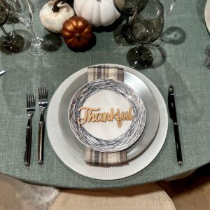 fall tablesetting in more blues and creams with linen, base plate, china, napkin, flatware, decor and a wooden carving that says Thankful
