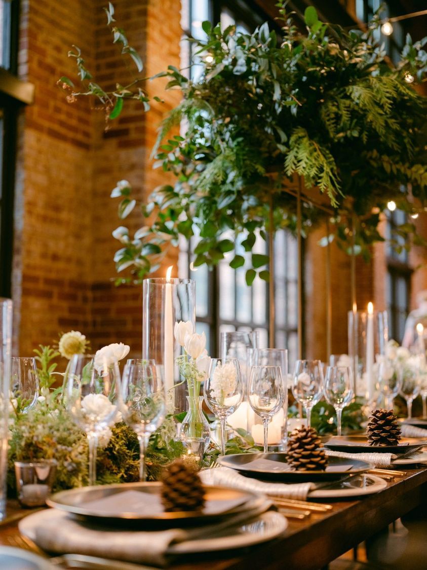 holiday table setting with nature elements like plants, flowers, pine cones