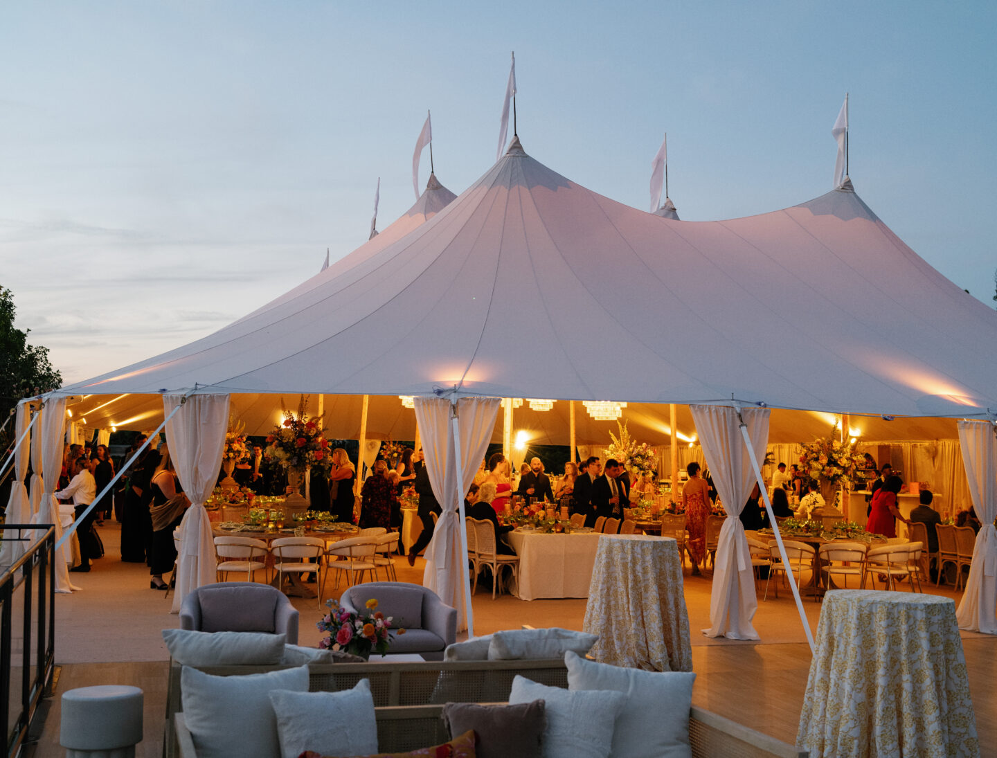 sperry sailcloth tent with seating arrangement infront during sunset