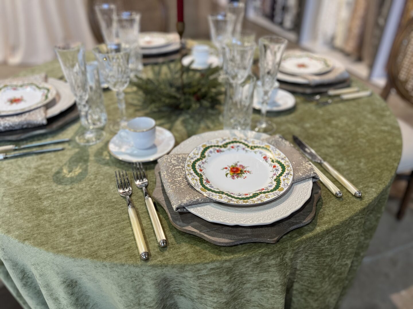 holiday table setting with moss green linen.