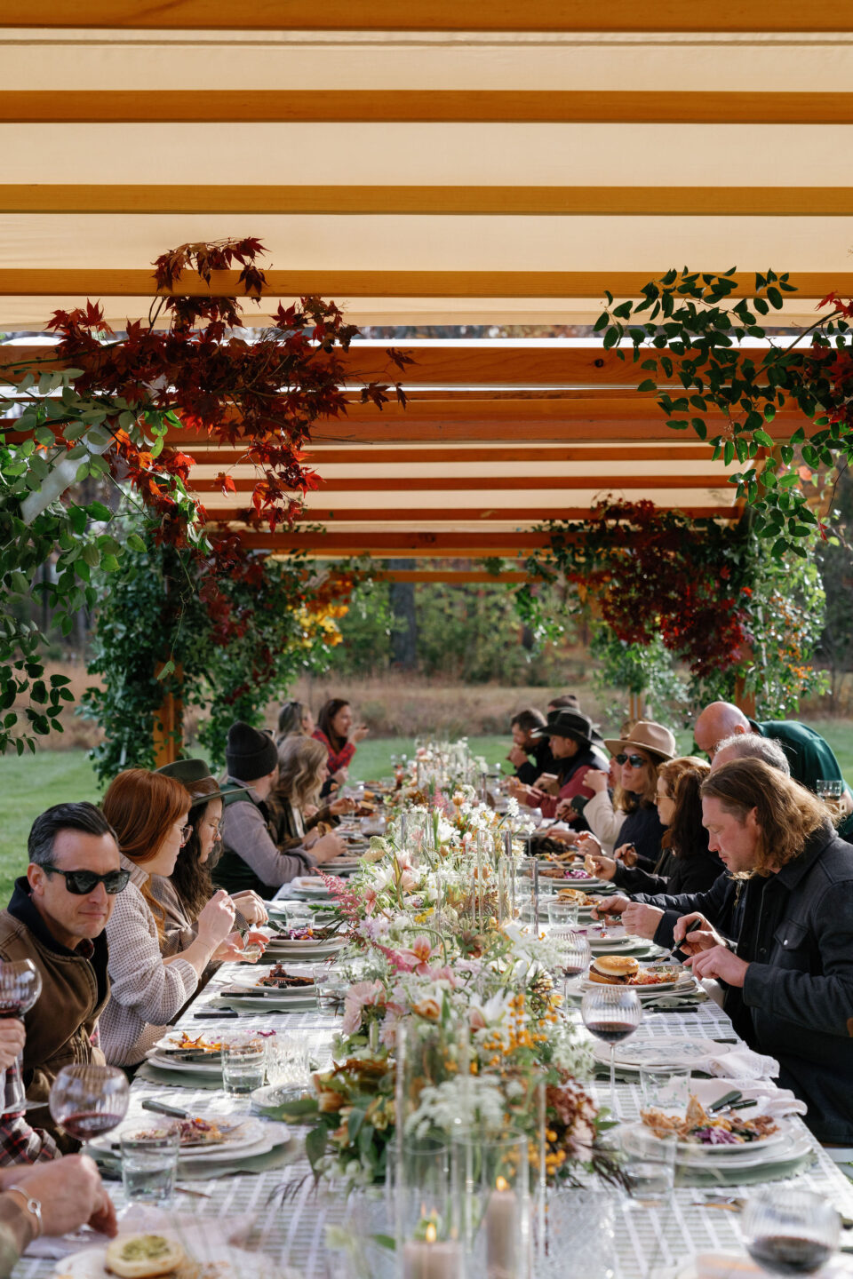 Group of people sitting at a dinner table under sperry arch