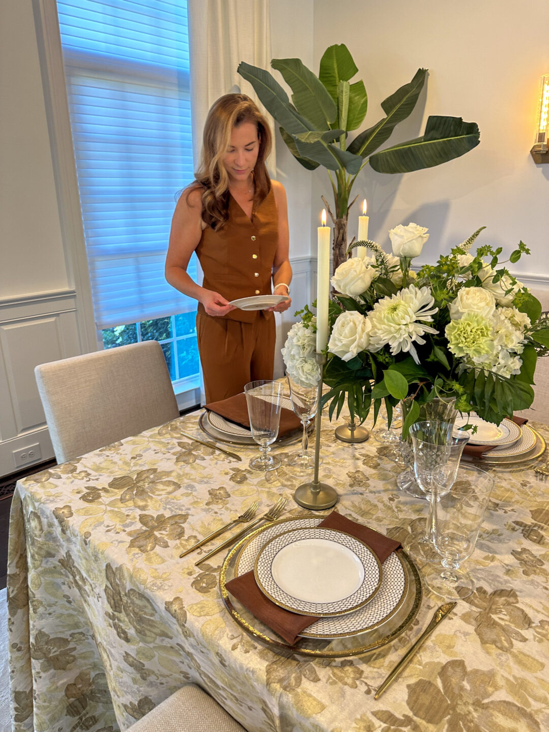 person setting classic cornucopia table 