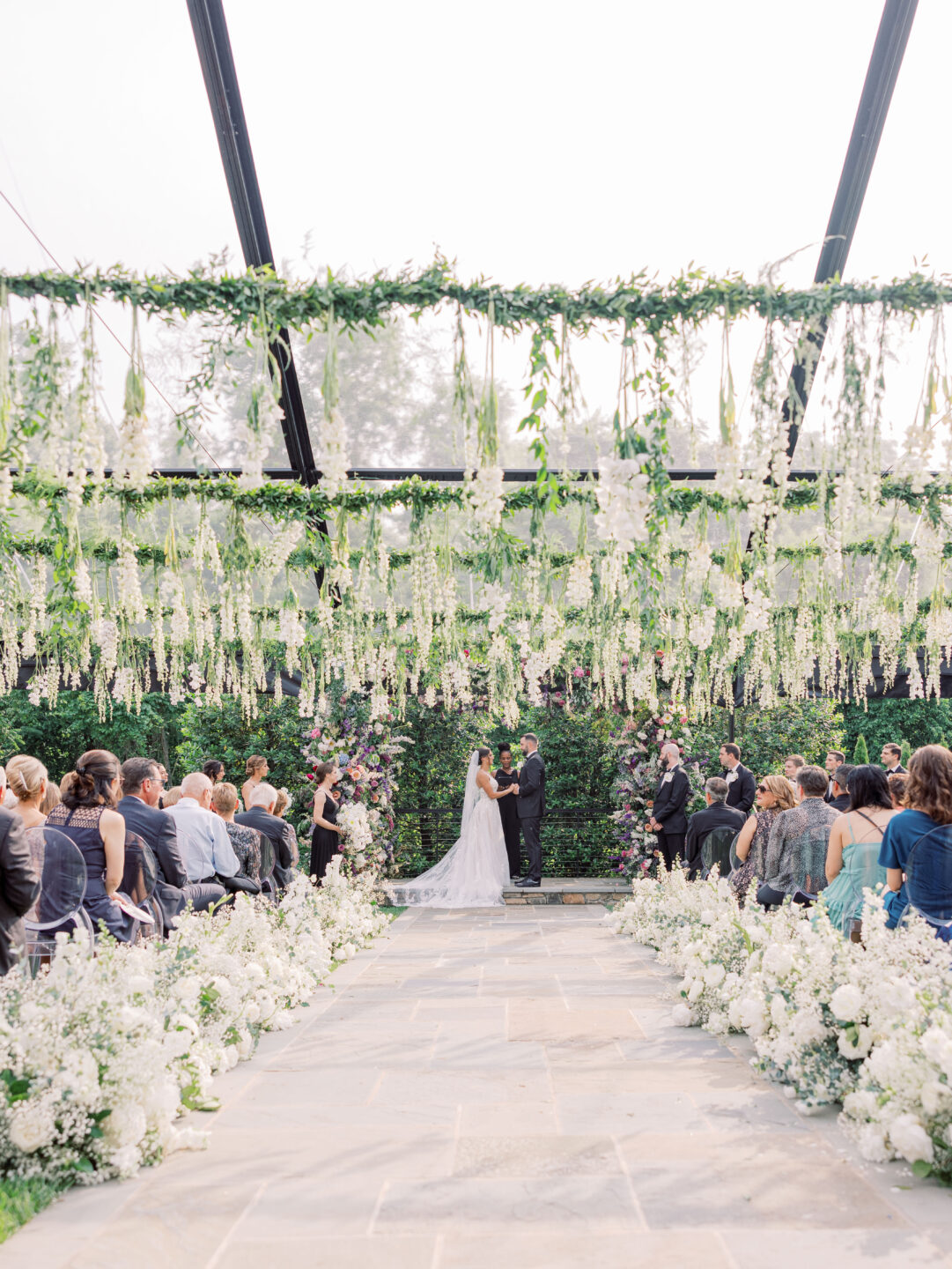 Wedding ceremony flower arrangements draping form the ceiling 