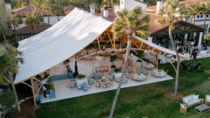 Exterior view of the Amelia Sperry Tent showcasing its elegant peaks and modern sailcloth design.