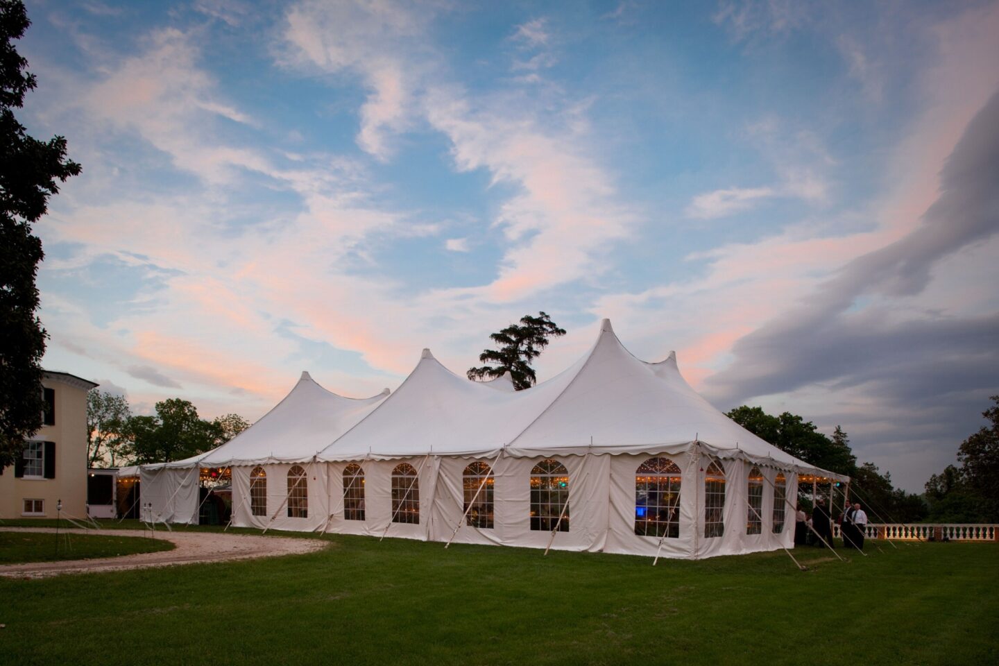 Select Event Group century pole tent with white vinyl top and cathedral-style sidewalls