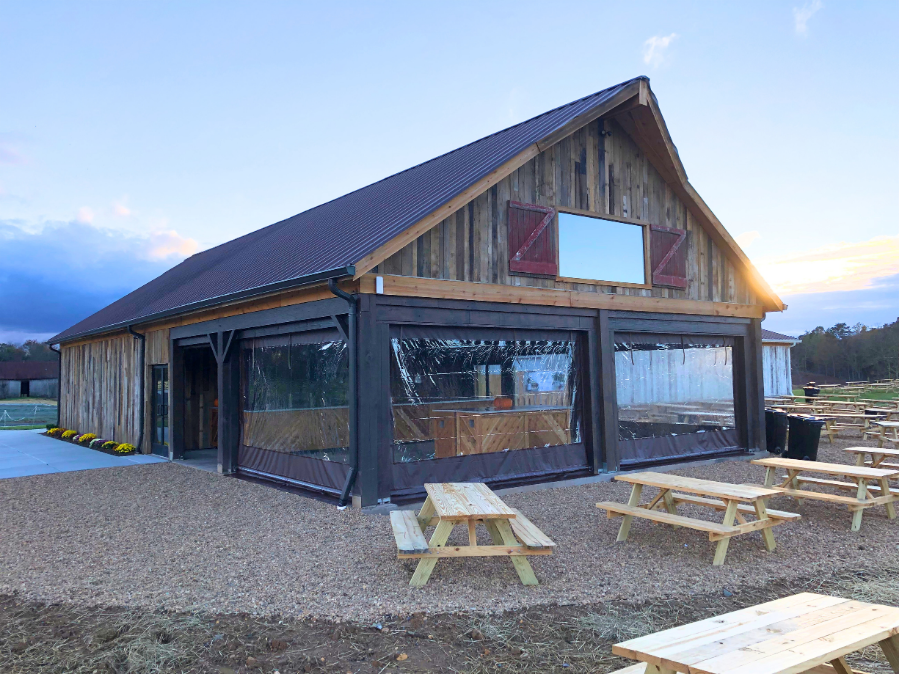 Clear vinyl patio enclosures and sidewalls extending outdoor seating during cold weather months.