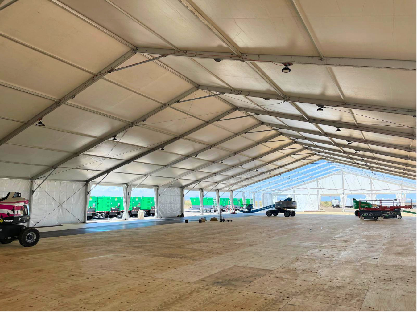Interior shot of a weatherproof job site structure constructed with white vinyl panels and temporary framing.