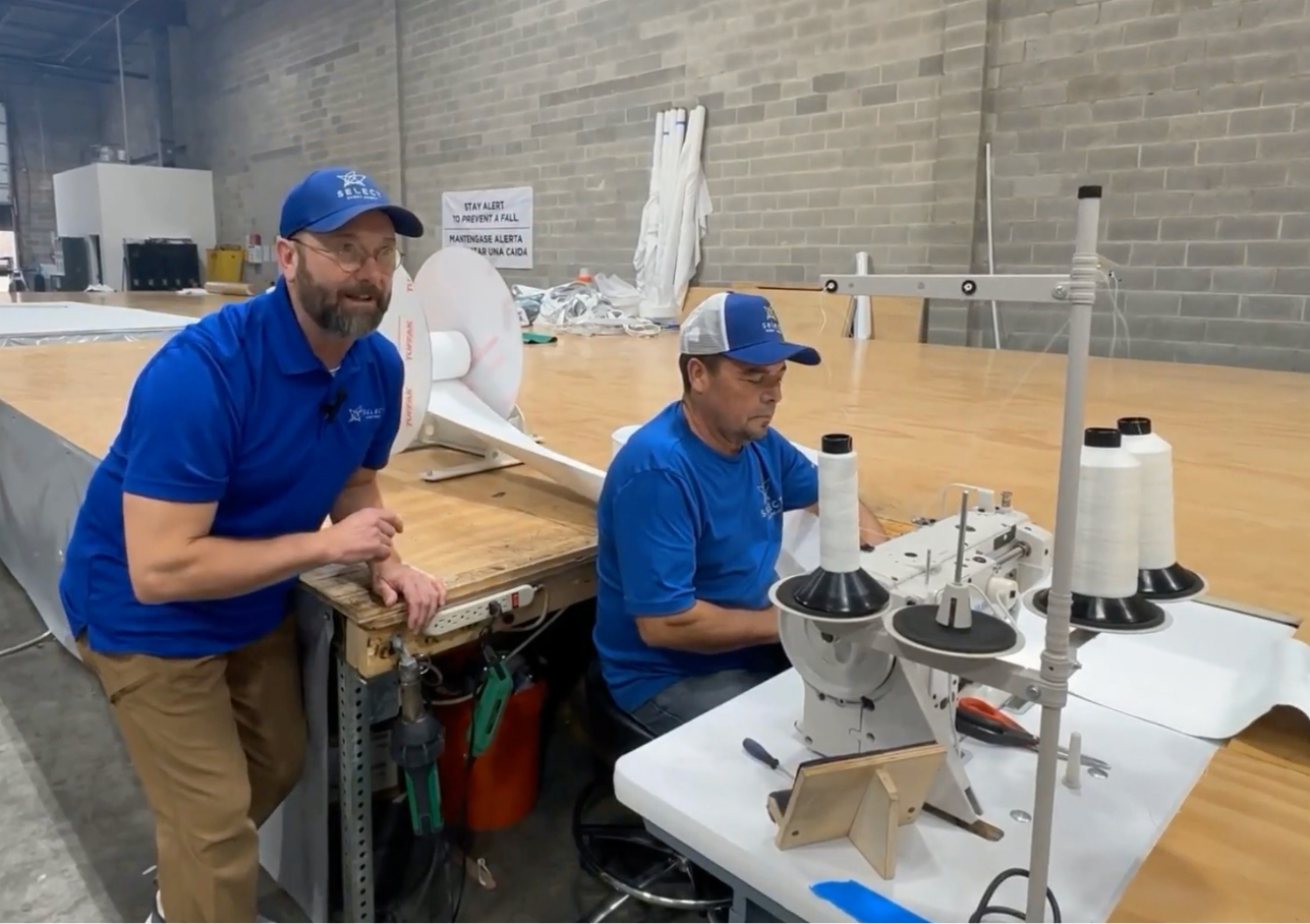 In-house vinyl manufacturing team members, including Lead Ray Stalcup, collaborating on the production floor at the Laurel Processing Center.